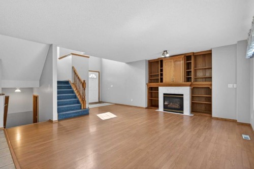 416 Douglas Glen Close Se, Calgary, AB - Indoor Photo Showing Living Room With Fireplace