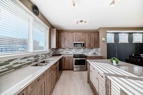 236 Sundown Road, Cochrane, AB - Indoor Photo Showing Kitchen With Double Sink With Upgraded Kitchen