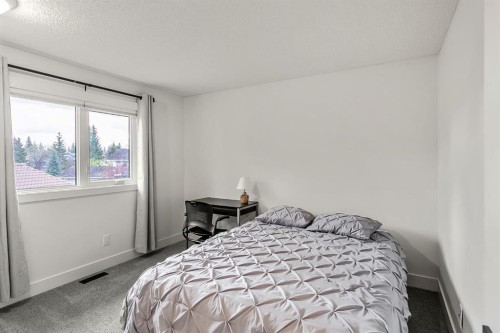 75 Woodacres Crescent Sw, Calgary, AB - Indoor Photo Showing Bedroom