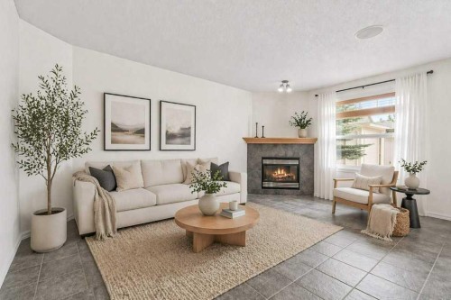 2317 Eversyde Avenue Sw, Calgary, AB - Indoor Photo Showing Living Room With Fireplace