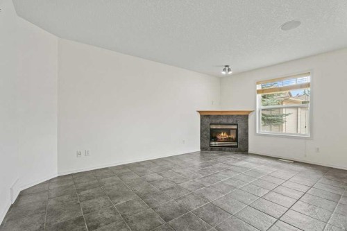 2317 Eversyde Avenue Sw, Calgary, AB - Indoor Photo Showing Living Room With Fireplace