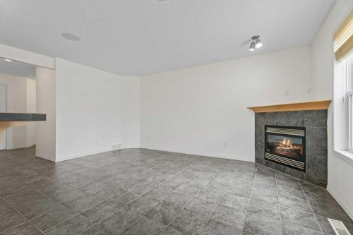 2317 Eversyde Avenue Sw, Calgary, AB - Indoor Photo Showing Other Room With Fireplace
