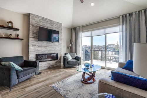 511 Kingsmere Way Se, Airdrie, AB - Indoor Photo Showing Living Room With Fireplace