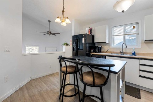 15 Erin Green Way Se, Calgary, AB - Indoor Photo Showing Kitchen With Double Sink