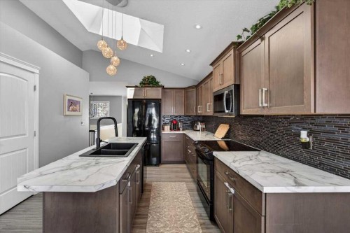 301 Mcleod Crescent, Diamond Valley, AB - Indoor Photo Showing Kitchen With Double Sink With Upgraded Kitchen