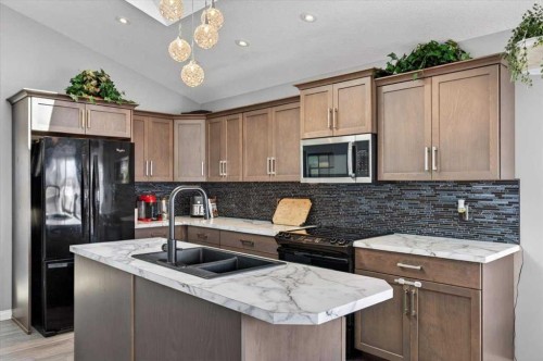 301 Mcleod Crescent, Diamond Valley, AB - Indoor Photo Showing Kitchen With Double Sink With Upgraded Kitchen