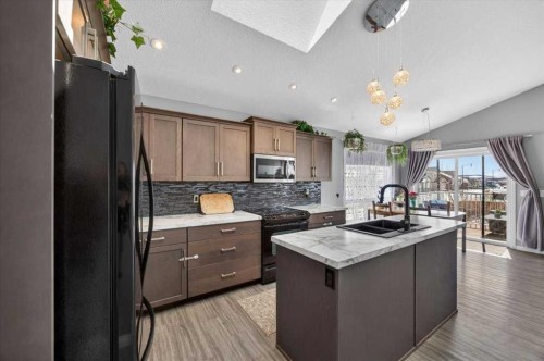 301 Mcleod Crescent, Diamond Valley, AB - Indoor Photo Showing Kitchen With Double Sink With Upgraded Kitchen