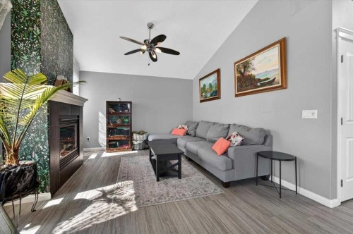 301 Mcleod Crescent, Diamond Valley, AB - Indoor Photo Showing Living Room With Fireplace