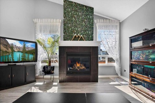301 Mcleod Crescent, Diamond Valley, AB - Indoor Photo Showing Living Room With Fireplace