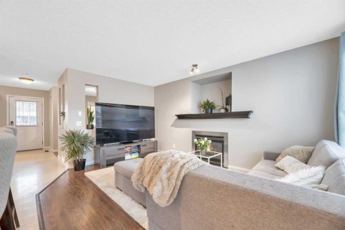 84 Evermeadow Manor Sw, Calgary, AB - Indoor Photo Showing Living Room With Fireplace