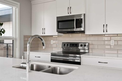 409-4350 Seton Drive Se, Calgary, AB - Indoor Photo Showing Kitchen With Double Sink With Upgraded Kitchen