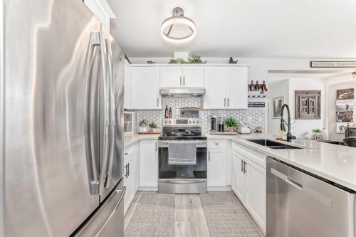 15 Spring Meadows Bay, Okotoks, AB - Indoor Photo Showing Kitchen With Stainless Steel Kitchen With Double Sink With Upgraded Kitchen