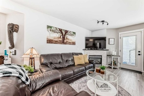 15 Spring Meadows Bay, Okotoks, AB - Indoor Photo Showing Living Room With Fireplace