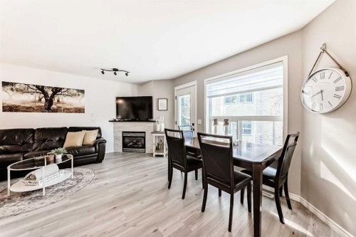 15 Spring Meadows Bay, Okotoks, AB - Indoor Photo Showing Dining Room With Fireplace