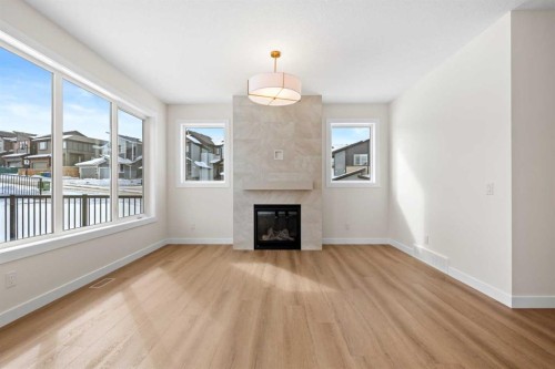 305 Precedence View, Cochrane, AB - Indoor Photo Showing Living Room With Fireplace