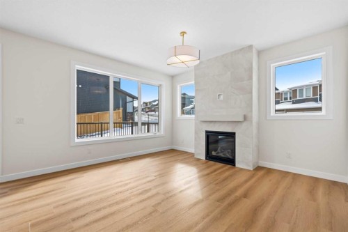 305 Precedence View, Cochrane, AB - Indoor Photo Showing Living Room With Fireplace