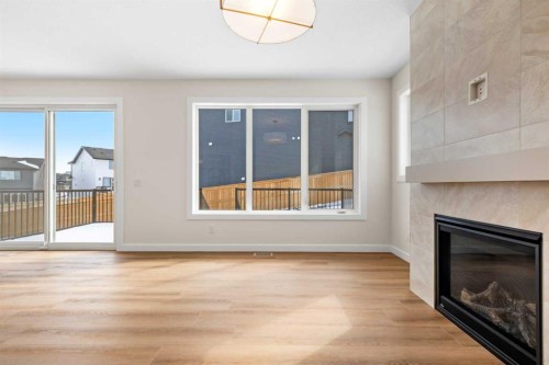 305 Precedence View, Cochrane, AB - Indoor Photo Showing Living Room With Fireplace