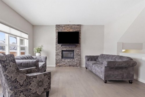 132 Sundown Way, Cochrane, AB - Indoor Photo Showing Living Room With Fireplace