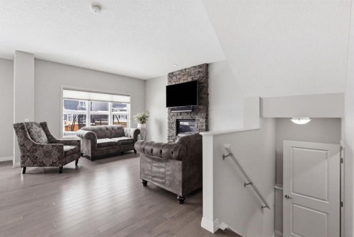 132 Sundown Way, Cochrane, AB - Indoor Photo Showing Living Room With Fireplace