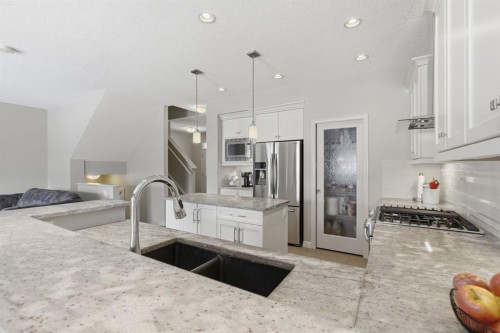132 Sundown Way, Cochrane, AB - Indoor Photo Showing Kitchen With Stainless Steel Kitchen With Double Sink With Upgraded Kitchen