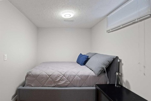 208 Woodpark Place Sw, Calgary, AB - Indoor Photo Showing Bedroom