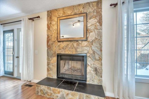 32 Midpark Drive Se, Calgary, AB - Indoor Photo Showing Living Room With Fireplace
