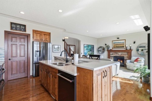 185 Sunset Circle, Cochrane, AB - Indoor Photo Showing Kitchen With Fireplace With Double Sink