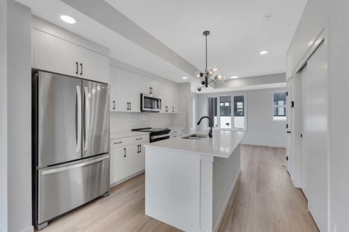 804A-120 Arbour Lake Court Nw, Calgary, AB - Indoor Photo Showing Kitchen With Stainless Steel Kitchen With Double Sink With Upgraded Kitchen