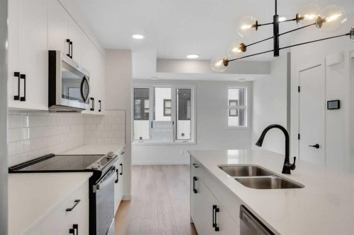 804A-120 Arbour Lake Court Nw, Calgary, AB - Indoor Photo Showing Kitchen With Stainless Steel Kitchen With Double Sink With Upgraded Kitchen