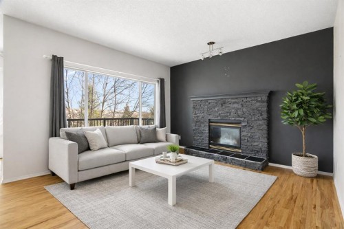 38 Bow Ridge Link Link, Cochrane, AB - Indoor Photo Showing Living Room With Fireplace