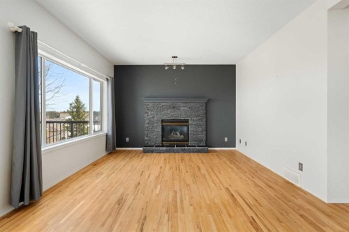 38 Bow Ridge Link Link, Cochrane, AB - Indoor Photo Showing Living Room With Fireplace