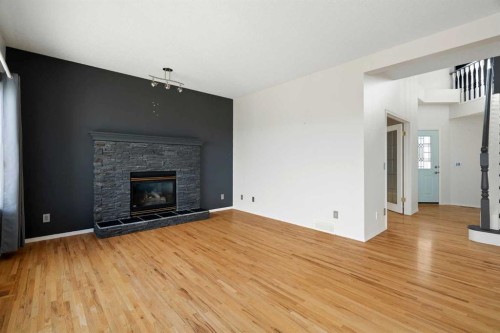 38 Bow Ridge Link Link, Cochrane, AB - Indoor Photo Showing Living Room With Fireplace