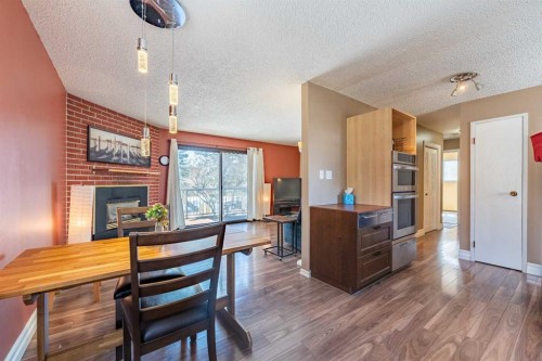 23 Mountain Place, Okotoks, AB - Indoor Photo Showing Dining Room With Fireplace