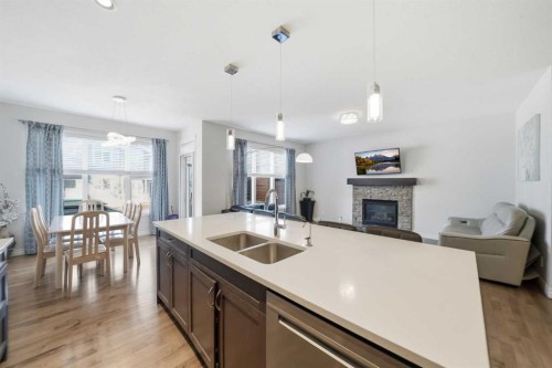 345 Evansglen Drive Nw, Calgary, AB - Indoor Photo Showing Kitchen With Fireplace With Double Sink