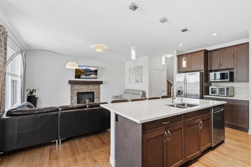 345 Evansglen Drive Nw, Calgary, AB - Indoor Photo Showing Kitchen With Fireplace With Double Sink With Upgraded Kitchen