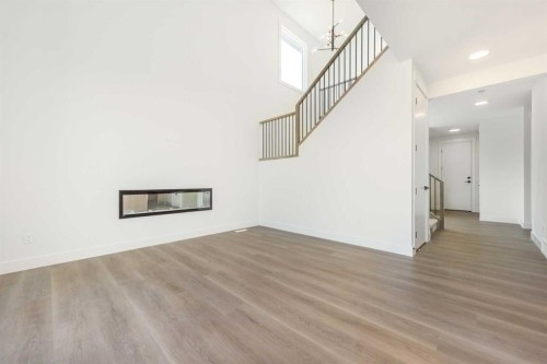 105 Waterford Passage, Chestermere, AB - Indoor Photo Showing Other Room With Fireplace
