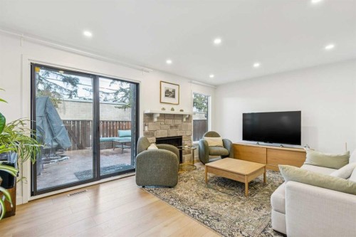 5-140 Point Drive Nw, Calgary, AB - Indoor Photo Showing Living Room With Fireplace