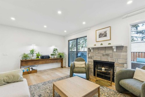 5-140 Point Drive Nw, Calgary, AB - Indoor Photo Showing Living Room With Fireplace