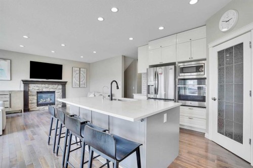 85 Evansborough Way Nw, Calgary, AB - Indoor Photo Showing Kitchen With Fireplace With Stainless Steel Kitchen With Upgraded Kitchen