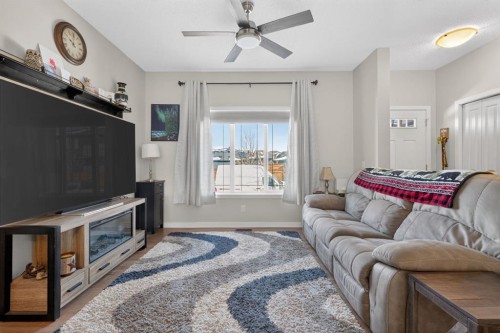 23 Belgian Link, Cochrane, AB - Indoor Photo Showing Living Room With Fireplace