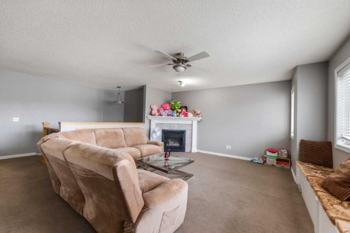 130 Invermere Drive, Chestermere, AB - Indoor Photo Showing Other Room With Fireplace