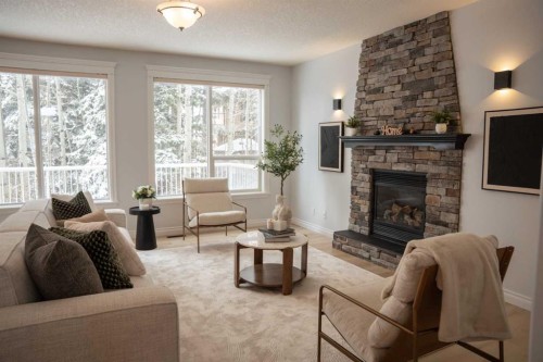 3 Strathridge Bay Sw, Calgary, AB - Indoor Photo Showing Living Room With Fireplace
