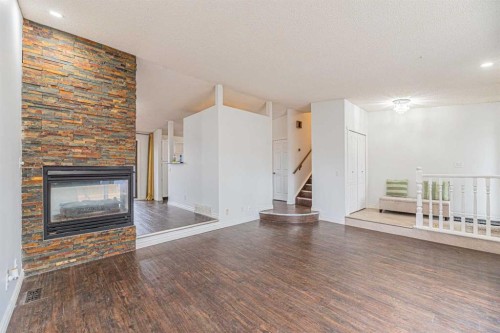 64 Castledale Crescent Ne, Calgary, AB - Indoor Photo Showing Living Room With Fireplace