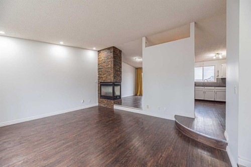 64 Castledale Crescent Ne, Calgary, AB - Indoor Photo Showing Other Room With Fireplace