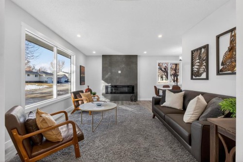 203 Lynnover Place Se, Calgary, AB - Indoor Photo Showing Living Room With Fireplace