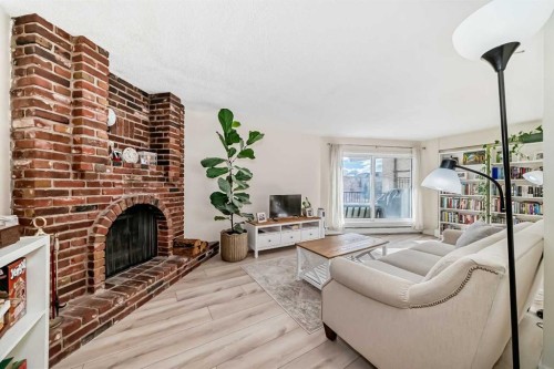 202-520 Cedar Crescent Sw, Calgary, AB - Indoor Photo Showing Living Room With Fireplace
