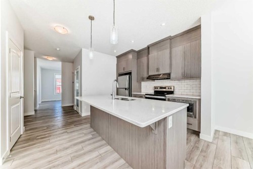 121 Ambleside Heath Nw, Calgary, AB - Indoor Photo Showing Kitchen With Double Sink With Upgraded Kitchen