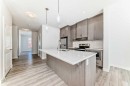 121 Ambleside Heath Nw, Calgary, AB  - Indoor Photo Showing Kitchen With Double Sink With Upgraded Kitchen 