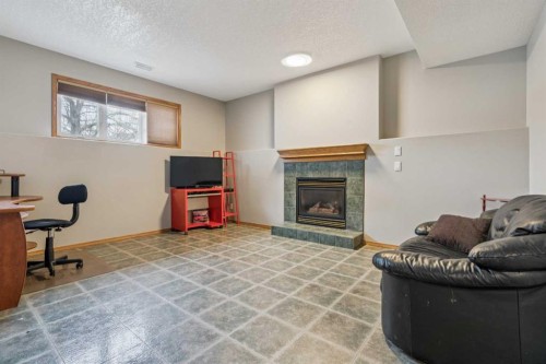 10 Bow Ridge Lane, Cochrane, AB - Indoor With Fireplace