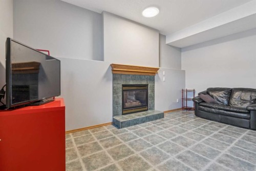 10 Bow Ridge Lane, Cochrane, AB - Indoor Photo Showing Living Room With Fireplace